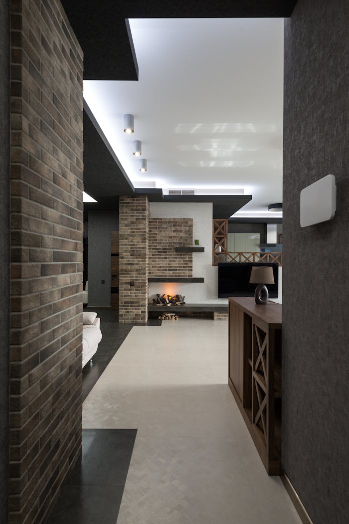 Modern living space featuring brick walls, ambient lighting, and stylish decor.